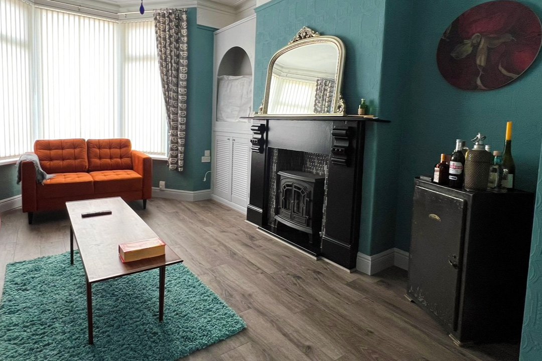 orange sofa with aqua blue rug